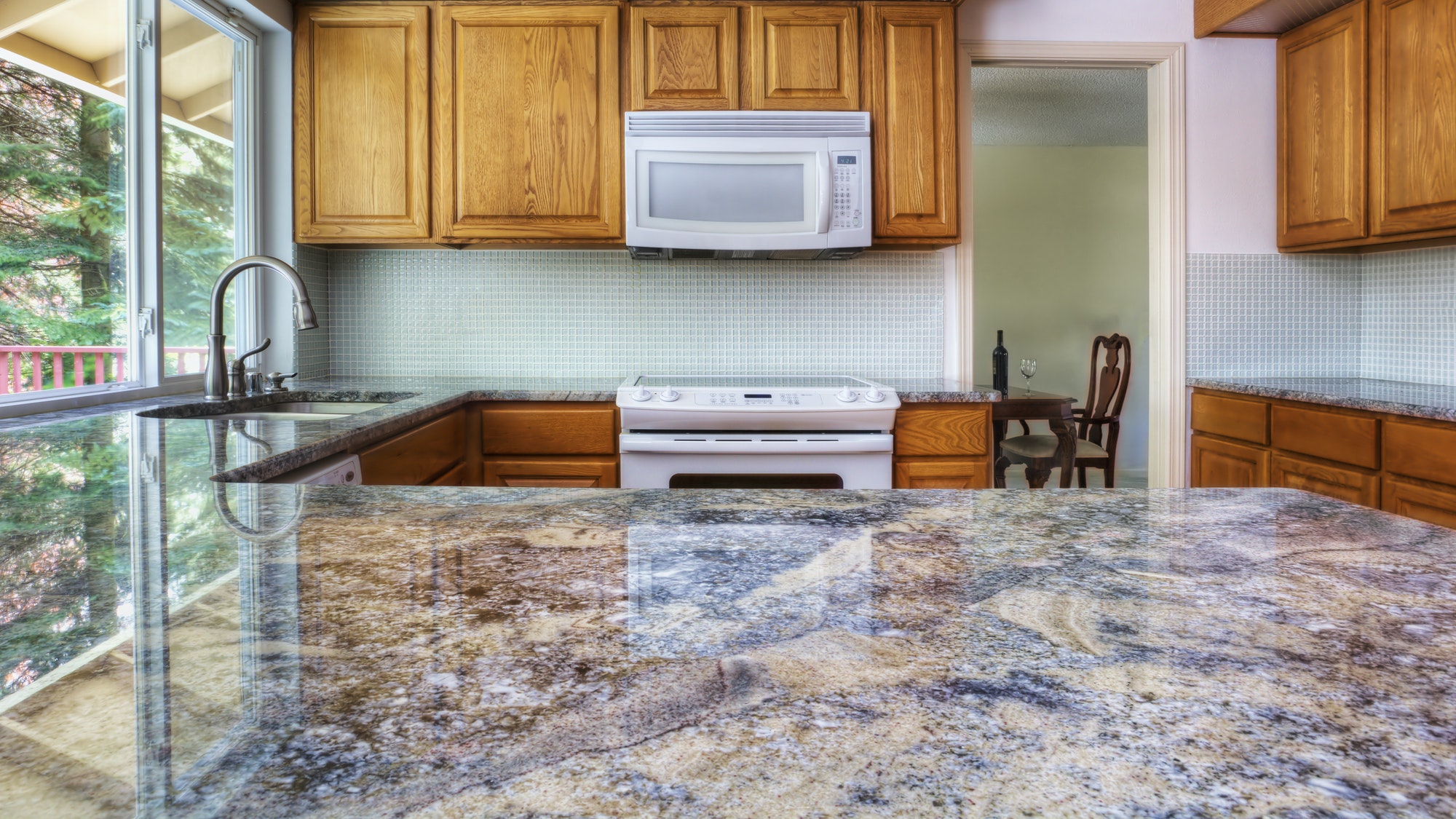 55289,Granite counter reflecting kitchen cabinets
